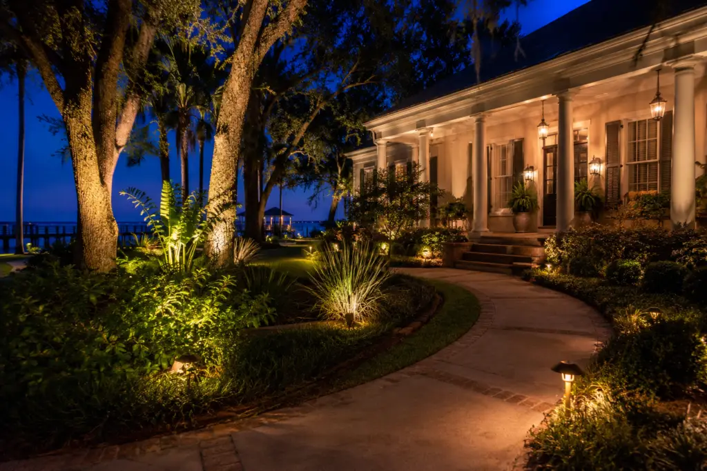Path and accent landscape lighting at a waterfront home