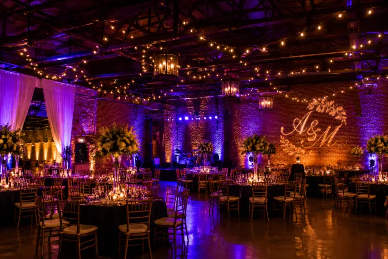 Event uplighting washing a reception venue in purple and blue